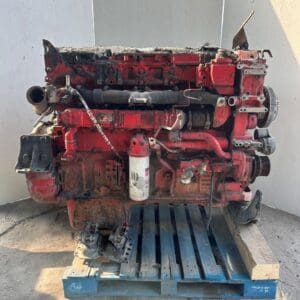 A red truck engine sitting on top of a pallet.