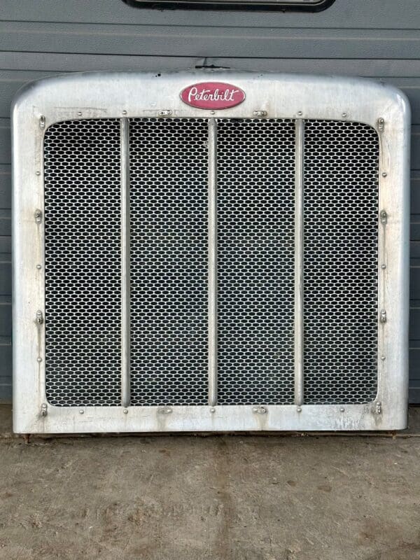 A radiator grille with the word " coca-cola " on it.