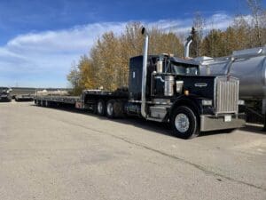 A semi truck is parked on the side of the road.